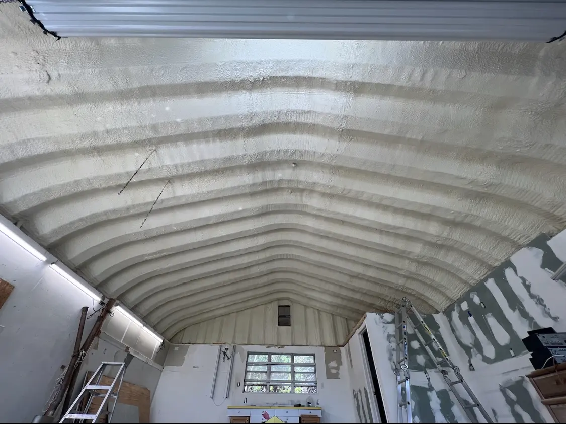 Spray polyurethane foam applied to the underside of a metal roof deck in North Liberty
